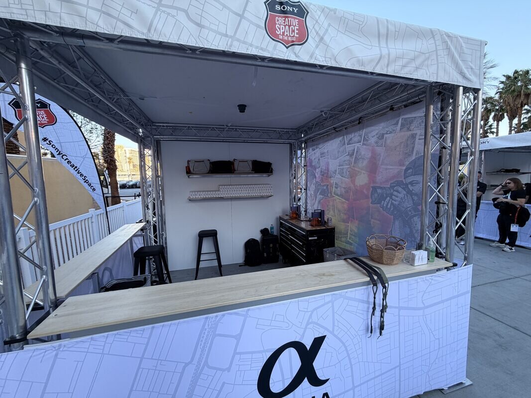 Branded truss booth build-out with counters and staging before doors open